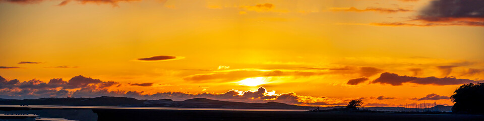 Yellow Panorama Sunset over Estuary, hills, horizon 