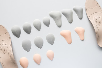 Orthopedic insoles on a white background. Treatment and prevention of flat feet and foot diseases. Foot care, foot comfort. Wear comfortable shoes.