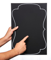 Black chalkboard held by a man with both hands.