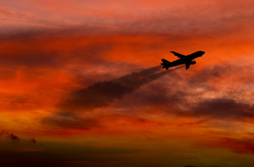 Airplane taking off at sunset. Silhouette of a big passenger or cargo aircraft, airline. Transportation.