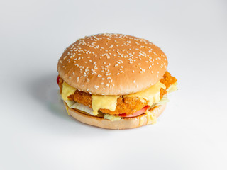 chicken burger with lettuce tomato and melted cheese in white background