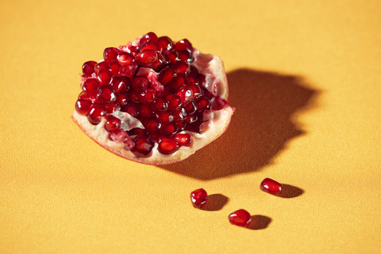 Closeup of pomegranate Seeds on a yellow background