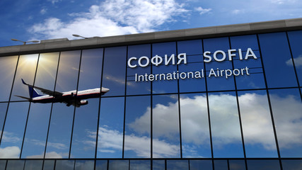 Airplane landing at Sofia mirrored in terminal