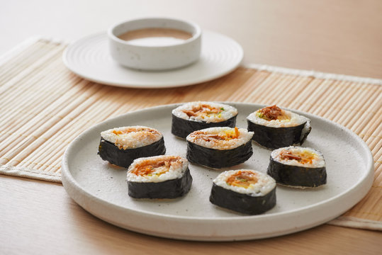 Gimbap is a Korean dish made from cooked rice and other ingredients that are rolled in gim?dried sheets of nori seaweed