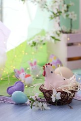 Happy Easter, colored eggs, toy chicken, twigs of blossoming cherry on the windowsill, spring, holiday decor