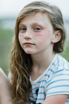 Portrait of Pensive young Redhead girl with Freckles