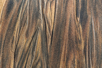 The texture of sea sand with traces of smudges