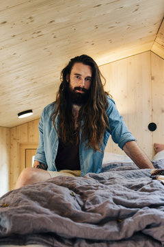 Portrait of Long-Haired Hipster on Bed