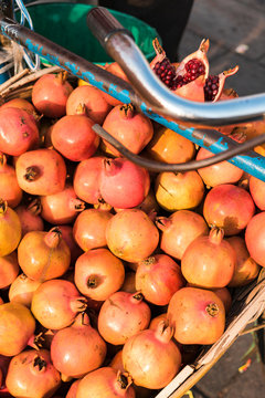 Bunch of colorful pomegranates in a basket