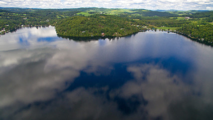Clouds reflecting on still lake water