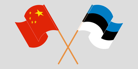 Crossed and waving flags of China and Estonia