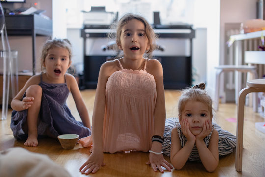 Three girls watching cartoons on a tablet