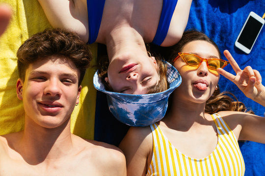 Overhead of best friends having fun on the beach.