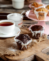 chocolate muffins served with a cup of black tea