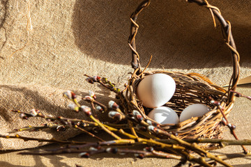 Easter unpaited white eggs in a basket pussy willow © Anna Lingvar