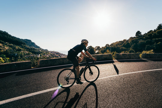 Male Road Cyclist Riding Coastal Road in Mallorca - Powered by Adobe