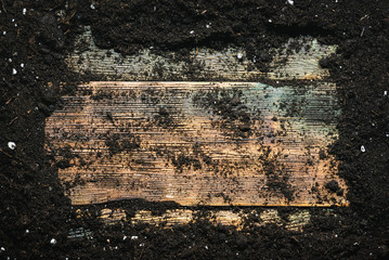 Garden soil on wooden table flat lay background with copy space.