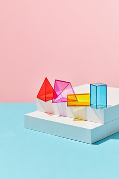 Set of multicolored shapes on a white box around a double blue-pink copy space