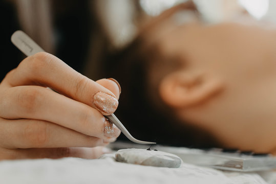 Process of a teenage girl having eyelash extensions put in
