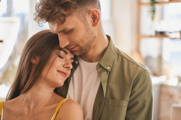Tender young woman leaning on her husband