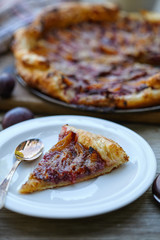 almond plum cake on puff pastry. Delicious piece of cake.