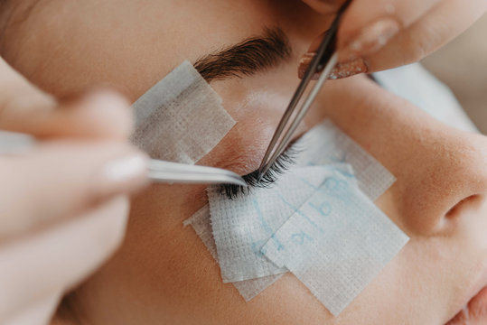 Process of a teenage girl having eyelash extensions put in
