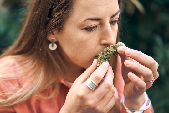 woman smelling a cannabis flower