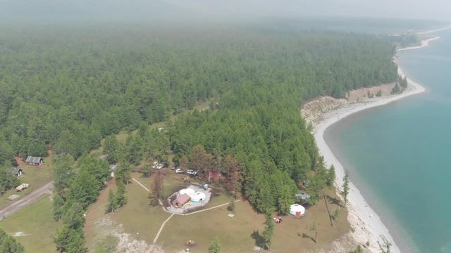 Amazing aerial tilt of a tourist gers camp at Khuvsgul Lake, in northern Mongolia