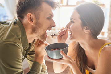 Close up of pretty girl that feeding her partner