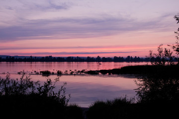 pink sunset on the river. after sunset. pink sky. reflection of the pink sunset sky on the water