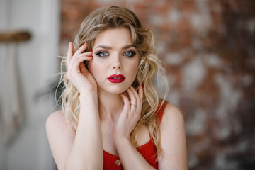 Beautiful fashion model Woman with blonde hair, Red lipstick . Fashion photos. Portrait of glamour girl with bright makeup. Beauty female face close up with perfect make up