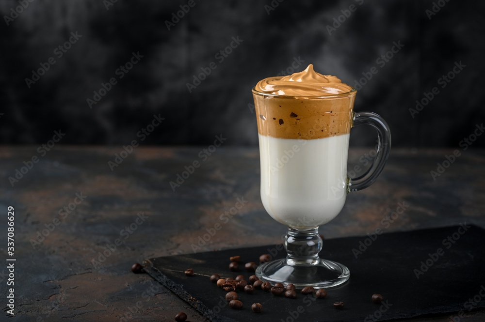 Wall mural glass cup with dalgona frothy coffee trend korean drink latte espresso with coffee foam