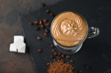 Glass cup with Dalgona frothy coffee trend korean drink latte espresso with coffee foam