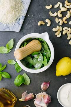 Making pesto in a motar with a pestle