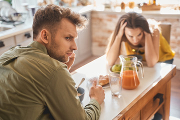Negative delighted man being deep in thoughts