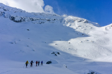 Group of skiers touring uphill