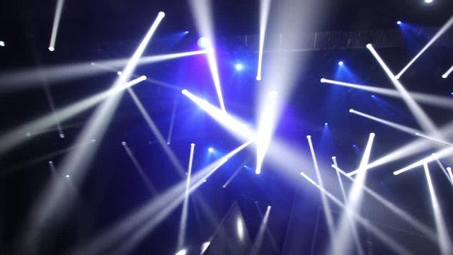Stage Ray Of Light In Concert Hall. Lighting lamp rays shiny dynamic effect. Laser lights on the stage.  Professional lighting and show effects.Professional lighting and show effects.