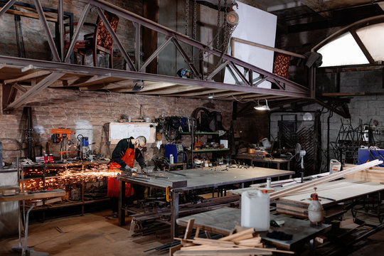 Metal worker in spacious industrial workshop