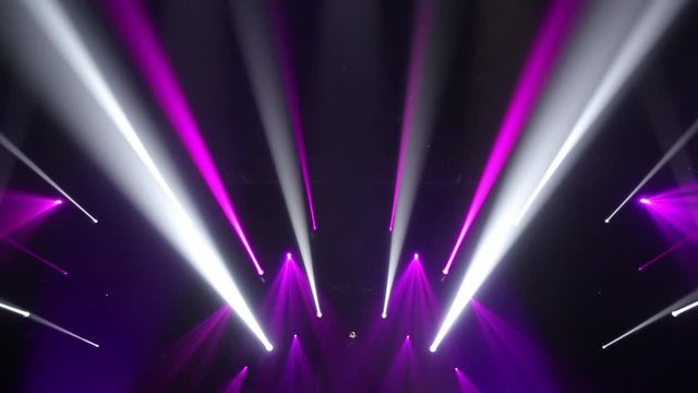 Stage Ray Of Light In Concert Hall. Lighting lamp rays shiny dynamic effect. Laser lights on the stage.  Professional lighting and show effects.Professional lighting and show effects.