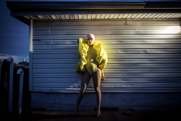 Glamorous Drag Queen in Yellow Leotard and Giant Scrunchie around her