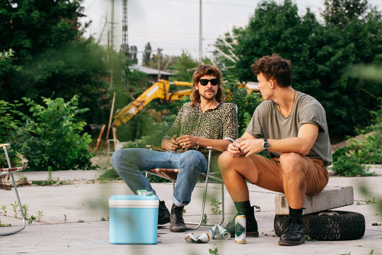 Two Young Guys Having Beers and Talking to Each Other
