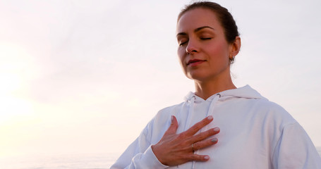Adult female breathing with hand on chest