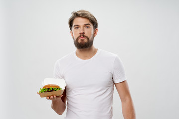 young man eating a hamburger