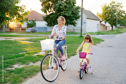 Mother and daughter driving a bicycle