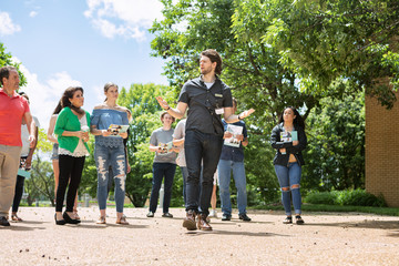 Tour: Guide Leads Group Through College Campus