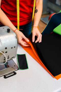 Close up of female tailor chosing color fabric