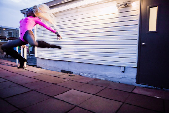 Drag Queen Dancing a Jumping Turn on a Rooftop