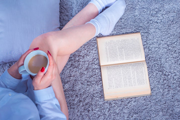 woman in home with old book and coffe