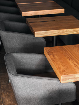 Gray armchairs near tables