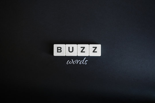 Buzzwords concept. Block letters and cursive font on black background. Minimal aesthetics.